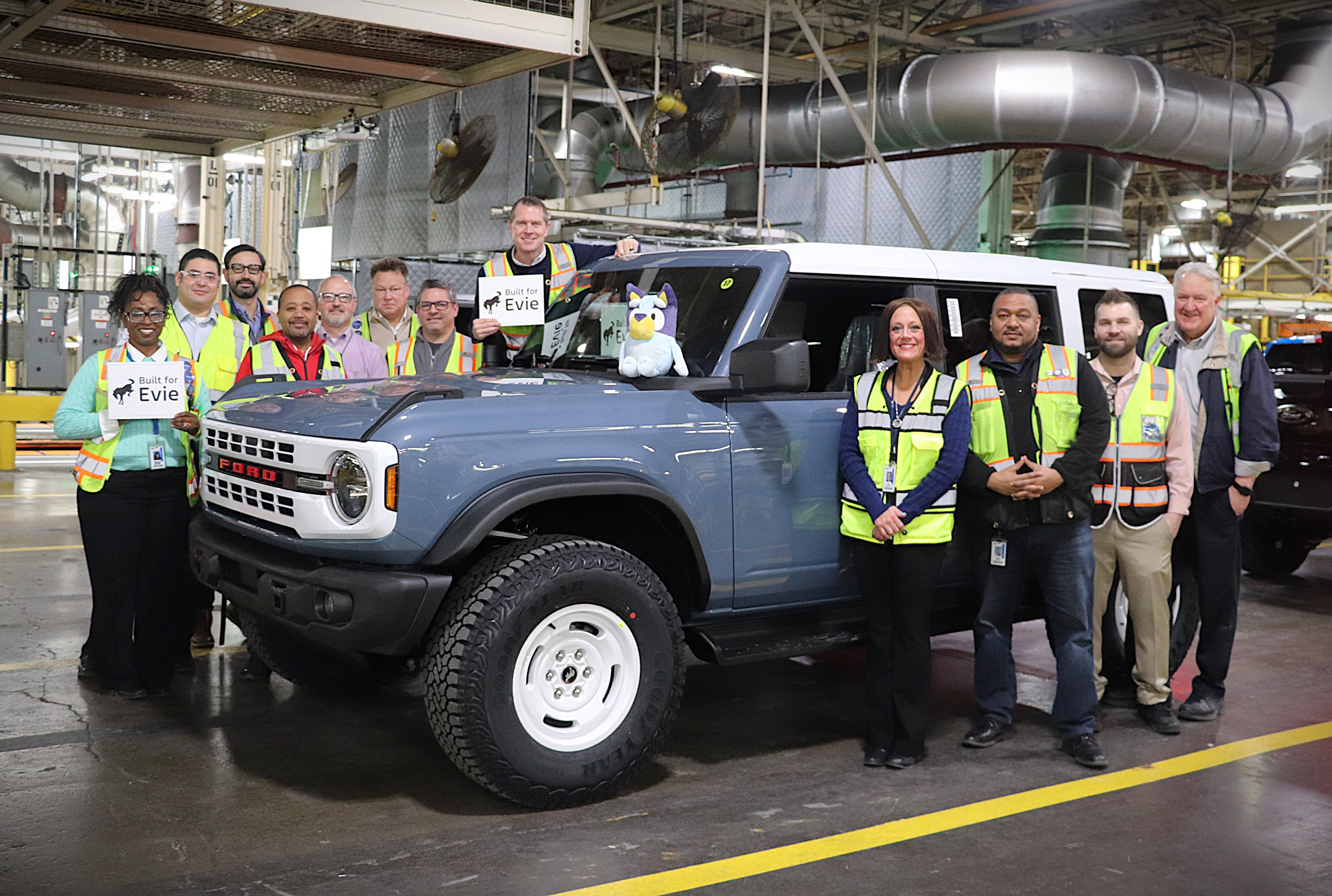 Michigan Assembly Plant employees posing with Bluey the Bronco.